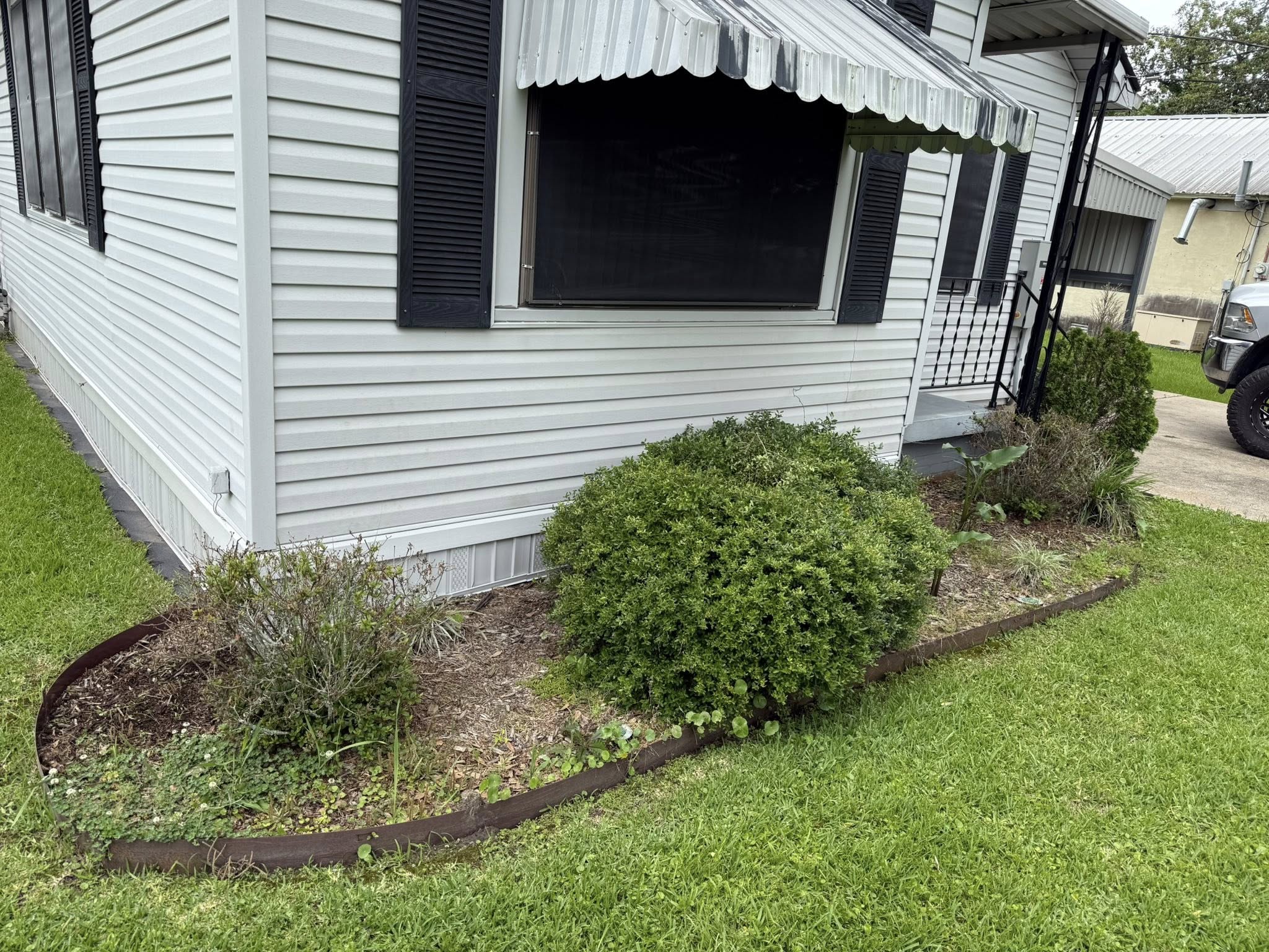 Garden area before Bailey's landscaping services